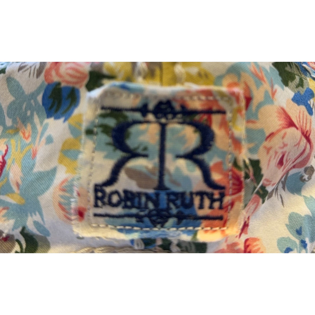 Second Half Supply Co, LLC Robin Ruth brand label patch on a cream floral quilted cotton snapback hat
