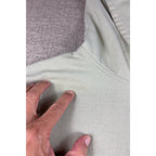 Second Half Supply Co, LLC sage green pullover hoodie showing a close-up of fabric discoloration on the shoulder