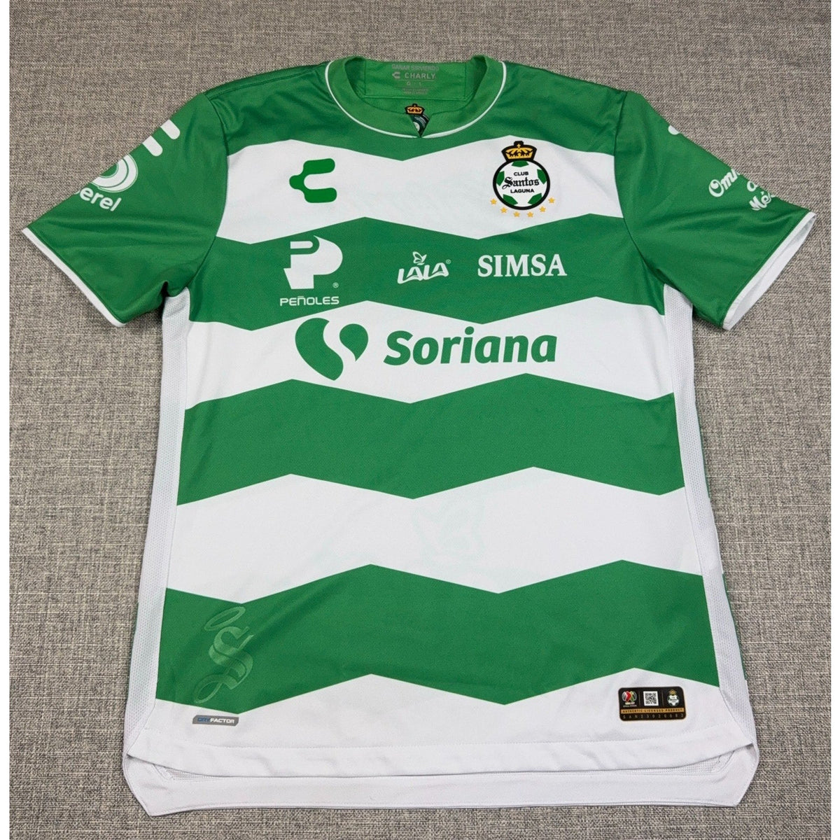 Second Half Supply Co, LLC Charly Santos Laguna 2023/24 home jersey in green and white with sponsor logos and crest.