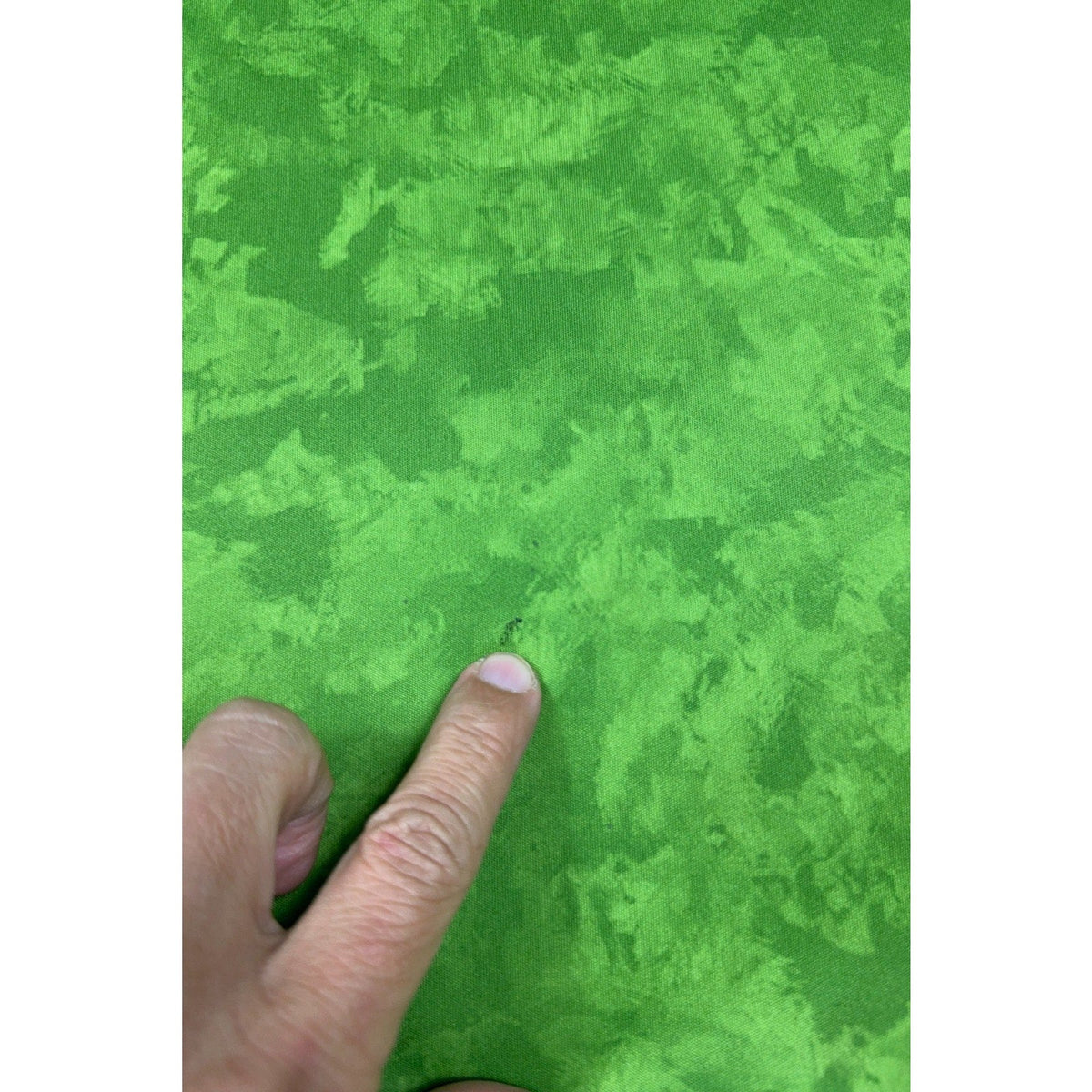 Second Half Supply Co, LLC Seattle Sounders jersey fabric showing a small dark mark on the bright green brushstroke