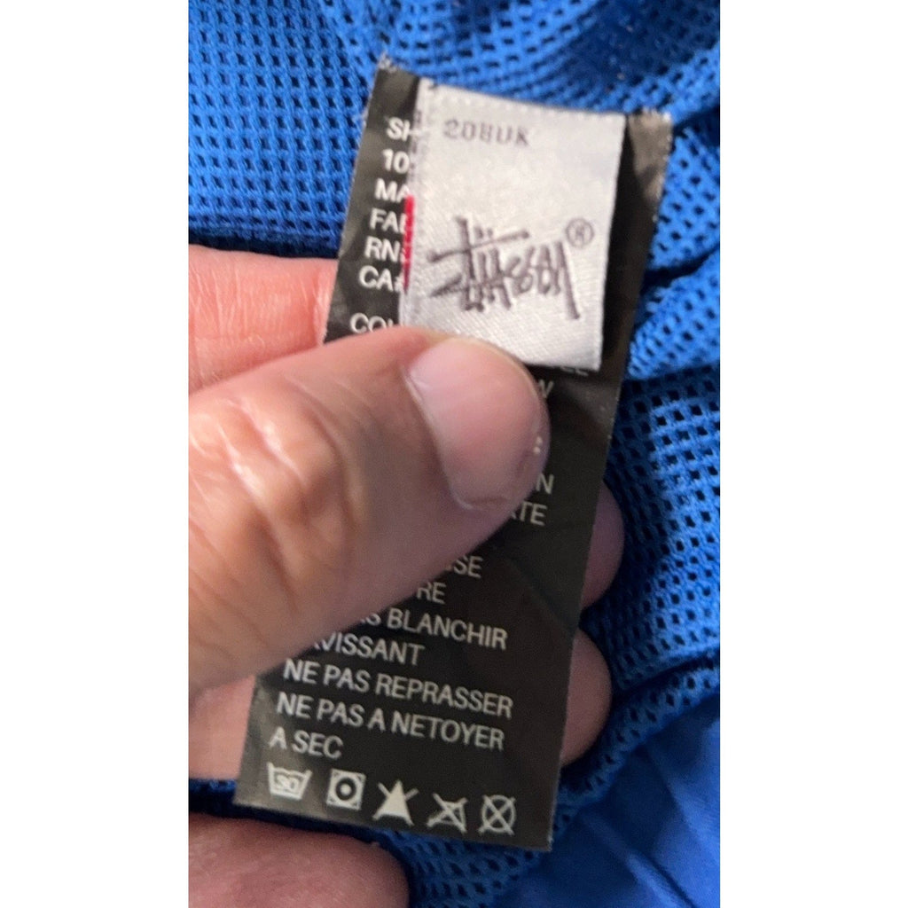 Second Half Supply Co, LLC Stussy Authentic Gear windbreaker interior care label with brand logo and washing symbols