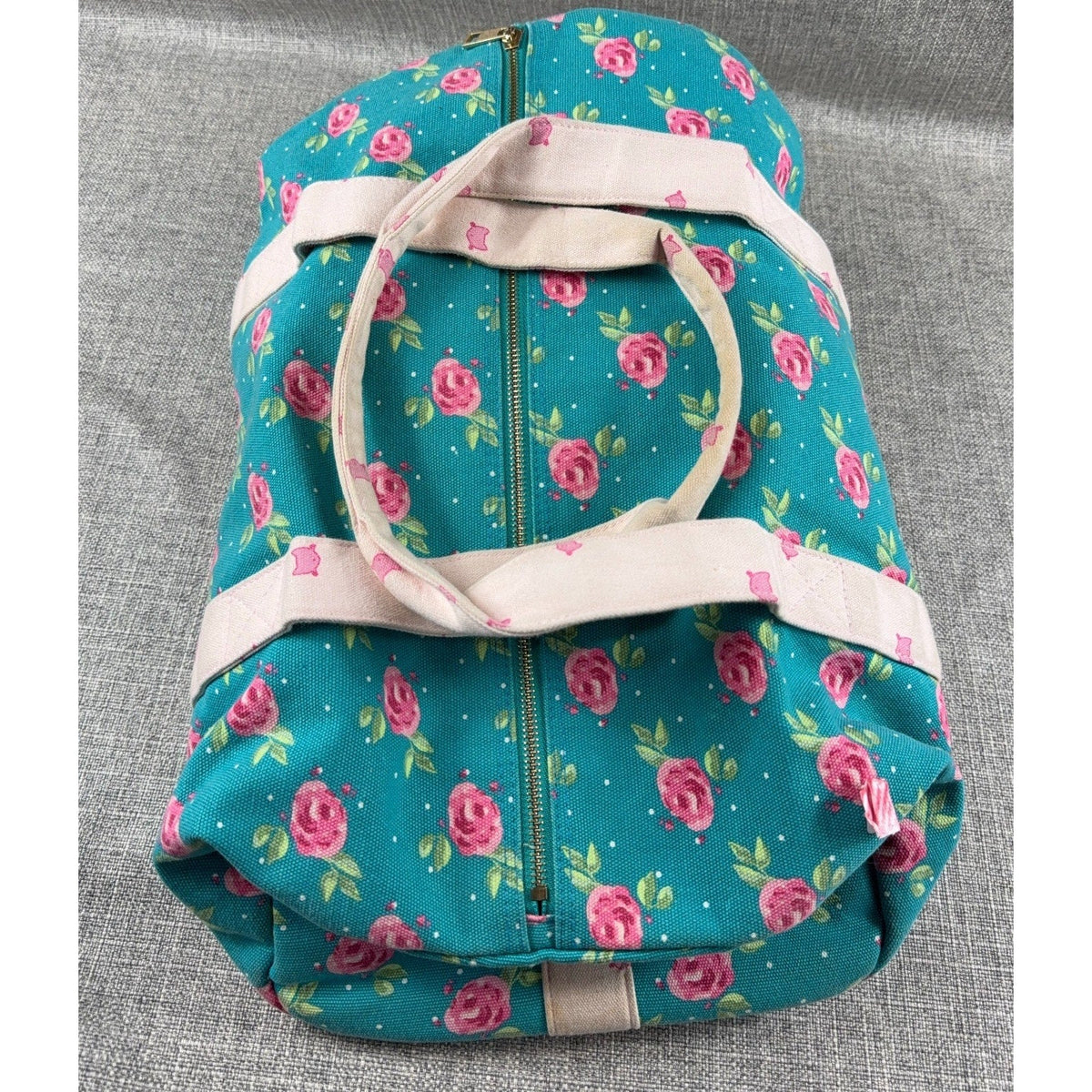 Second Half Supply Co, LLC Whim + Wander floral canvas duffel bag in teal with pink roses and pale pink straps.