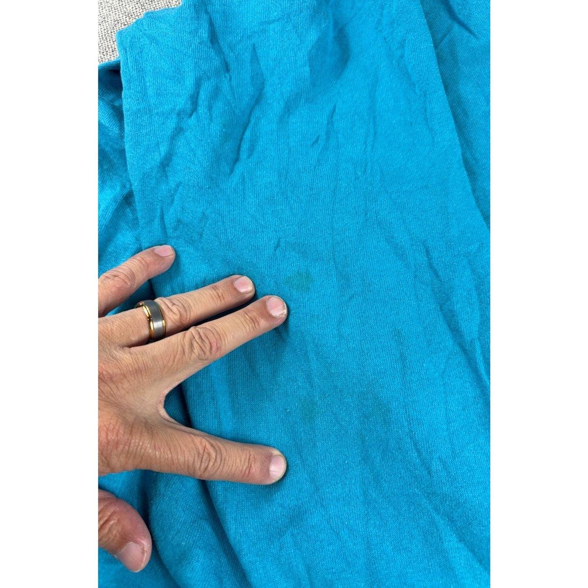 Second Half Supply Co, LLC vintage teal sweatshirt showing minor fabric spots on the cotton-polyester fleece material