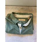 Second Half Supply Co, LLC Tommy Bahama men's green short sleeve polo shirt with collared neckline and button placket.