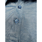 Second Half Supply Co, LLC heathered blue TravisMathew polo shirt with branded buttons and textured fabric detail