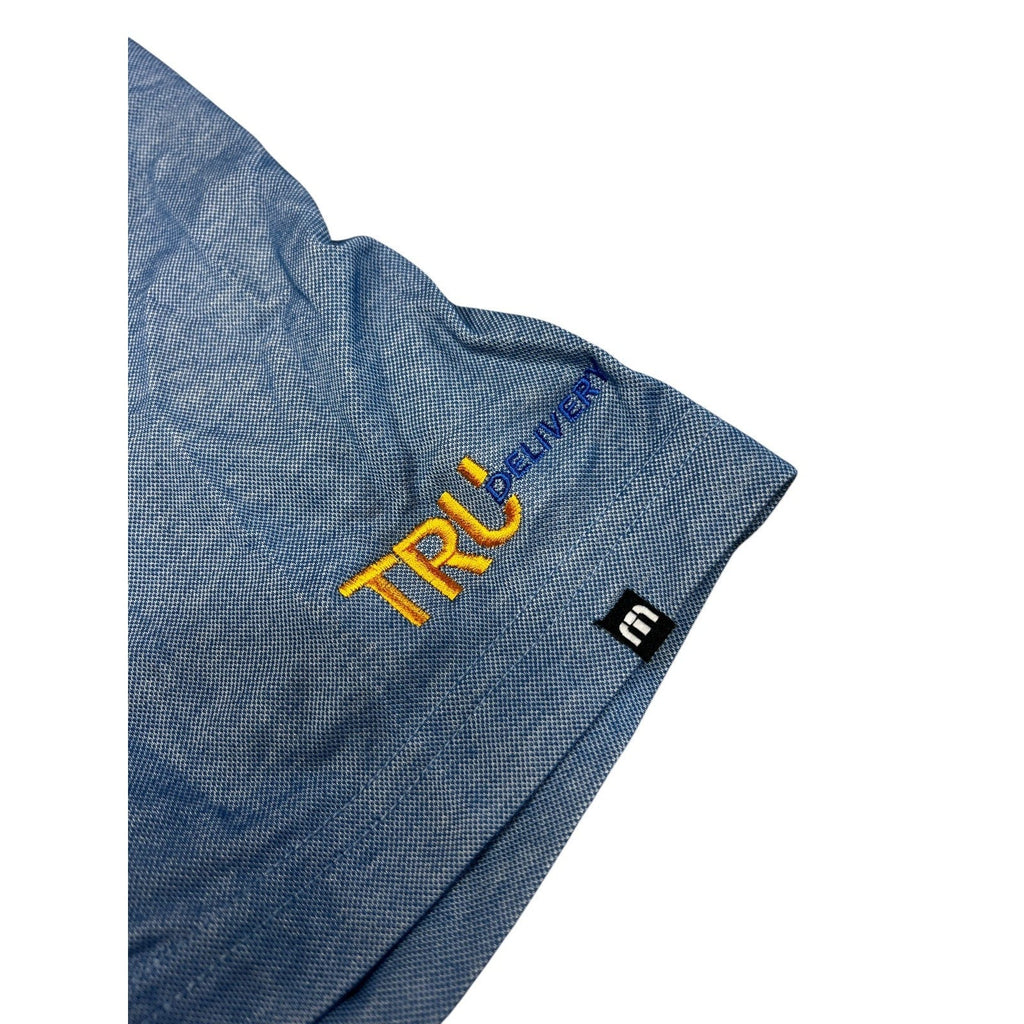 Second Half Supply Co, LLC heathered blue TravisMathew polo shirt sleeve with yellow and blue TRU Delivery embroidery