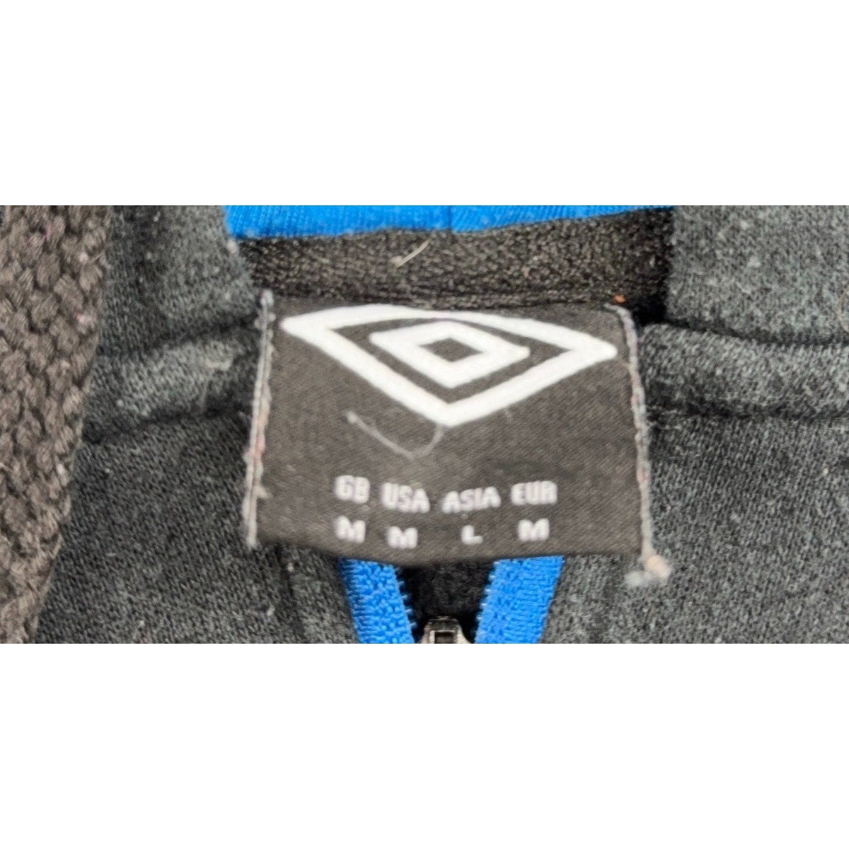 Second Half Supply Co, LLC Umbro hoodie interior neck label showing size medium and brand logo