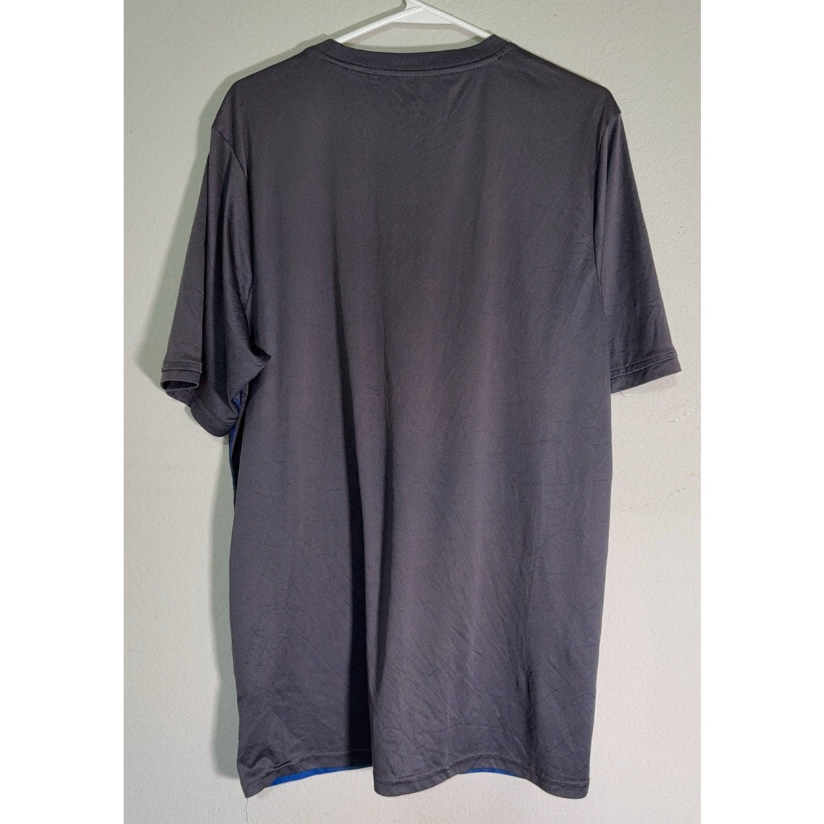 Back view of a Second Half Supply Co, LLC Umbro Italia blue and gray gradient polyester soccer training jersey