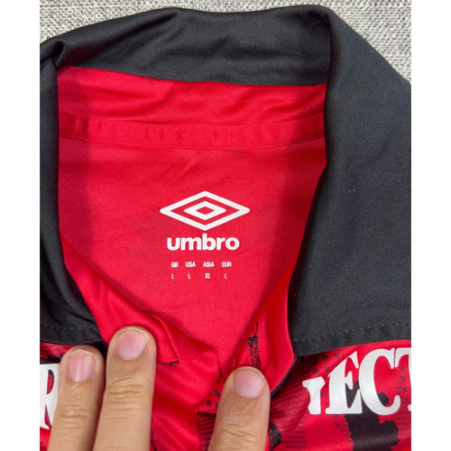 Second Half Supply Co, LLC Umbro Independiente Santa Fe jersey interior neck label showing size L and red black fabric