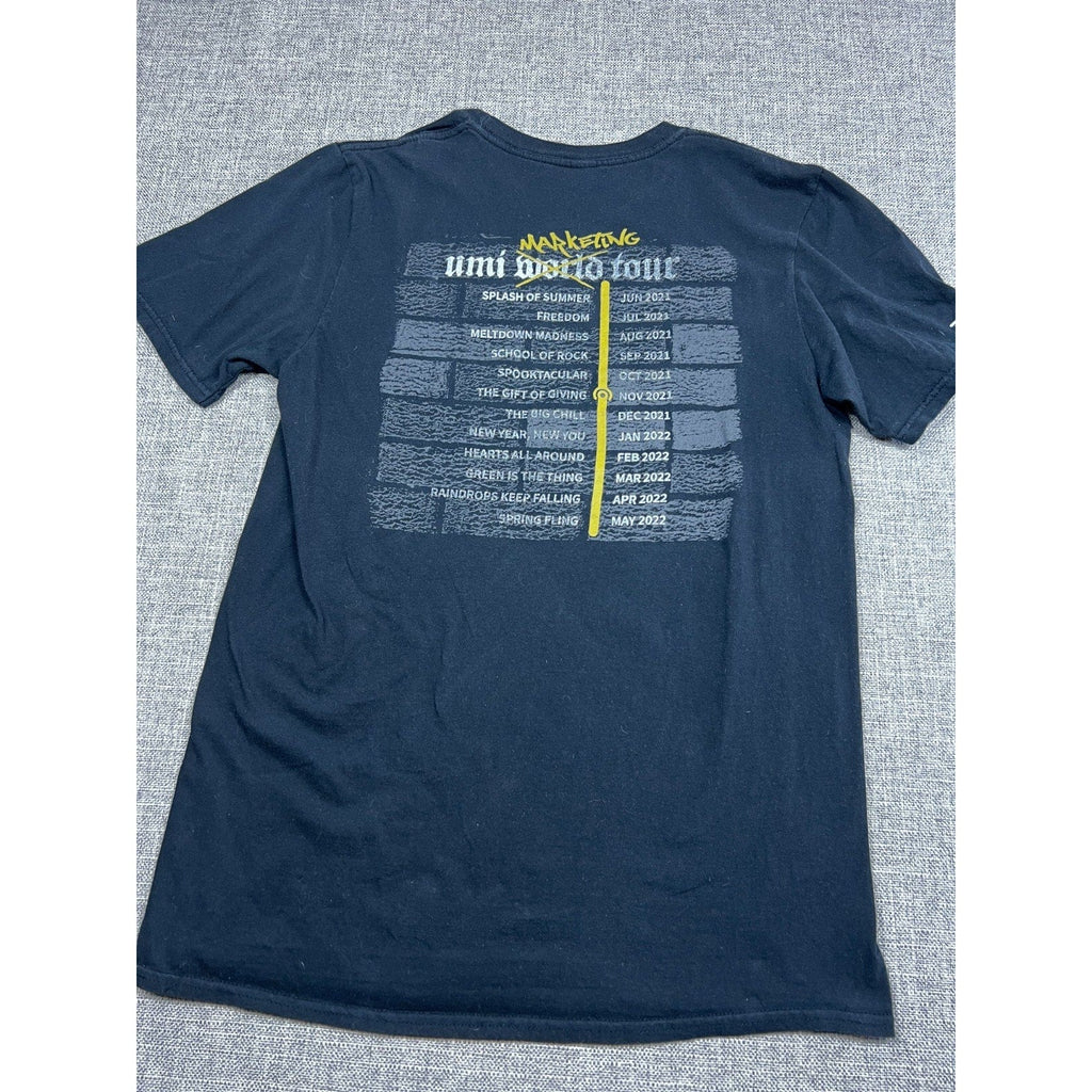Second Half Supply Co, LLC black crewneck t-shirt featuring a Umi World Tour event schedule graphic on the back