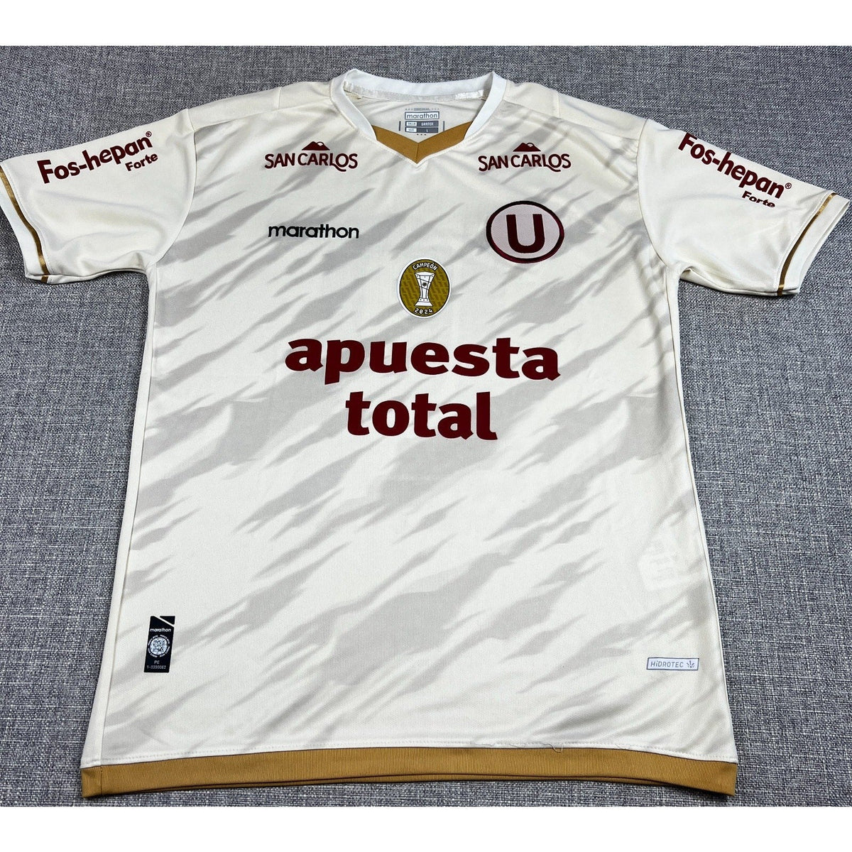 Second Half Supply Co, LLC Universitario 2025 home jersey in cream with gold trim and 2024 champion badge