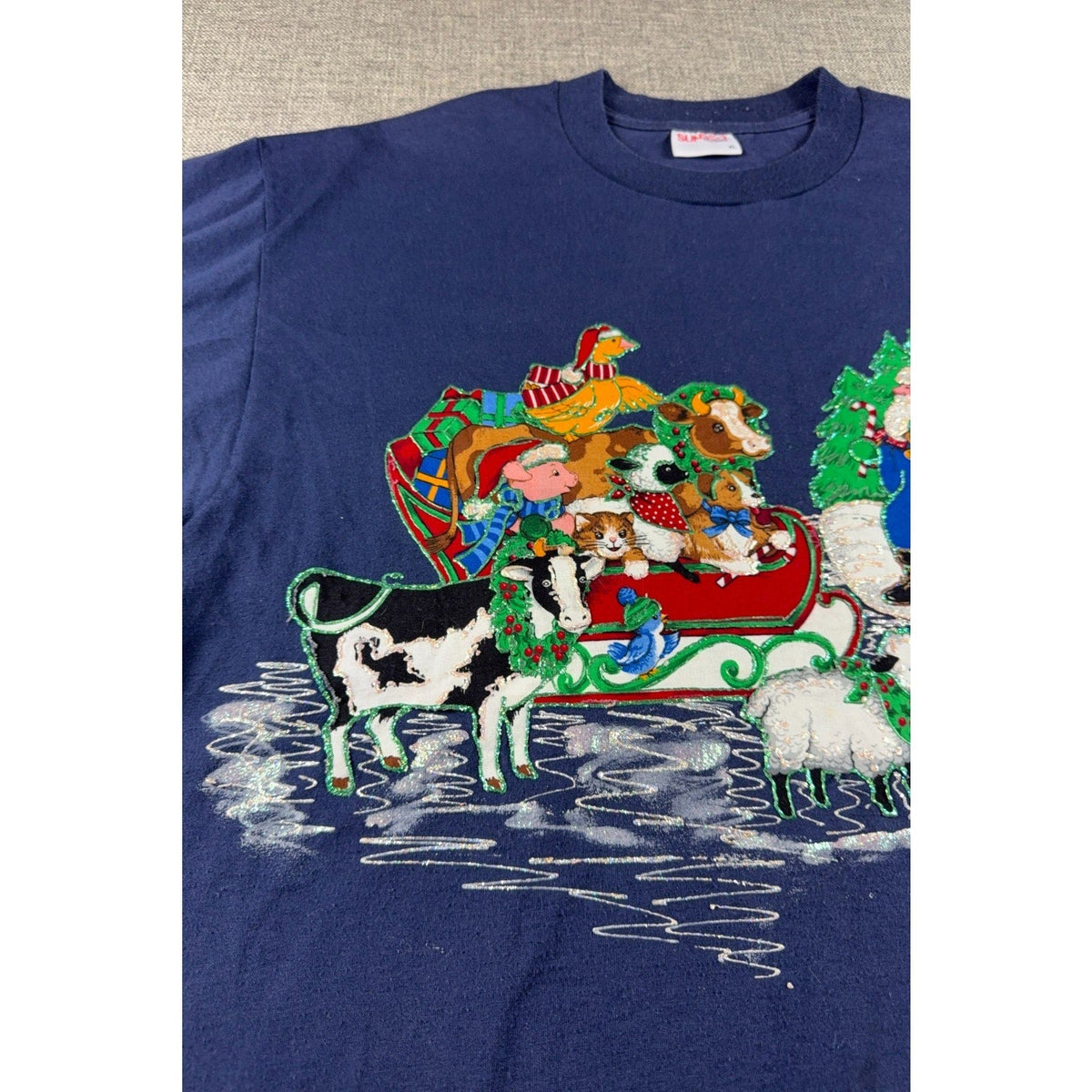 Second Half Supply Co, LLC vintage 90s navy blue Christmas t-shirt with glittery Santa and farm animal sleigh graphic
