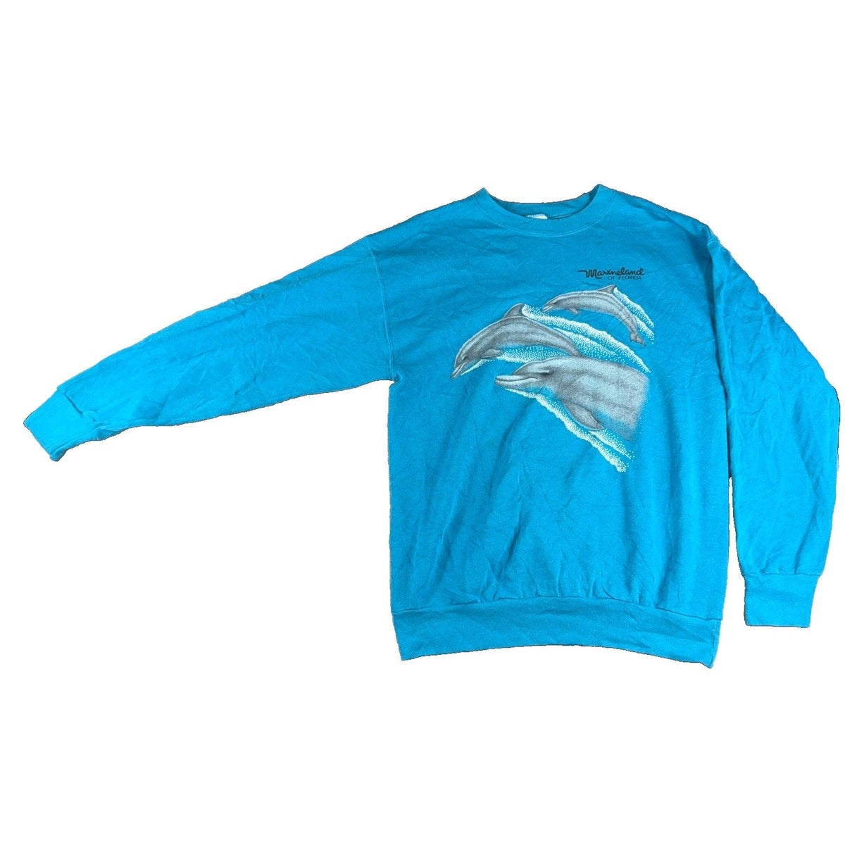 Second Half Supply Co, LLC vintage 90s teal crewneck sweatshirt featuring a Marineland of Florida dolphin graphic.