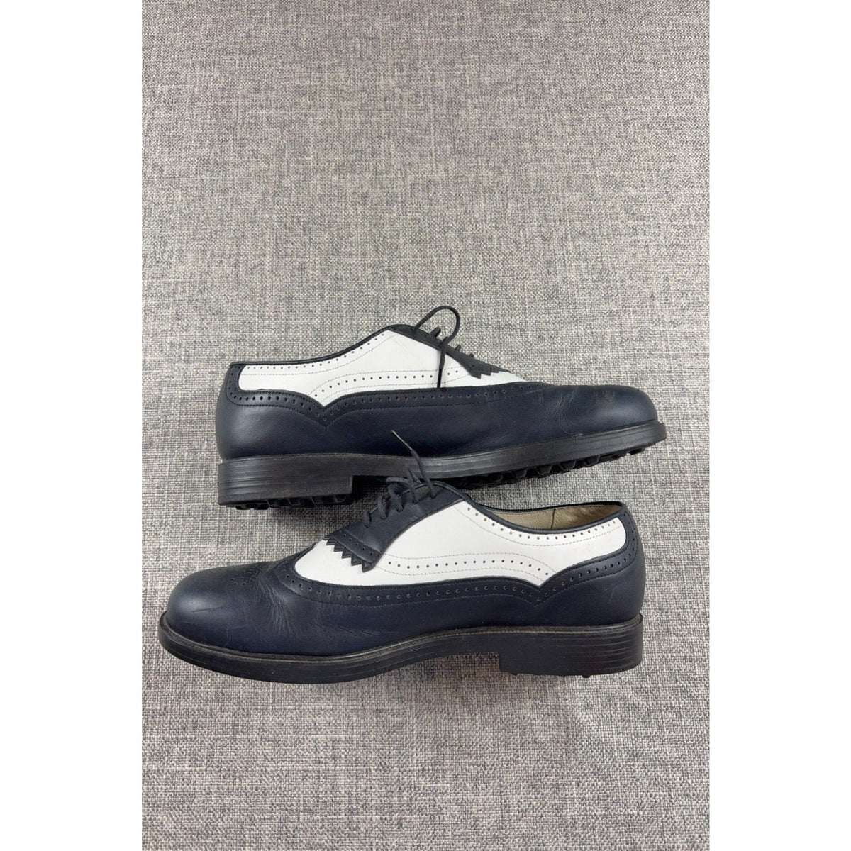 Second Half Supply Co, LLC vintage black and white leather wingtip golf shoes with brogue detailing and lace-up closure