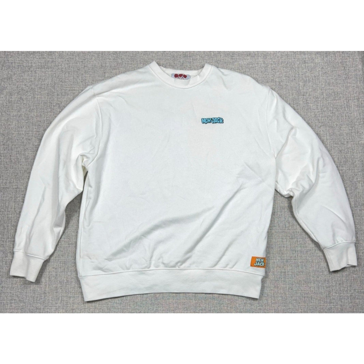 Second Half Supply Co, LLC white New Jack crewneck sweatshirt with turquoise chest logo and orange hem patch