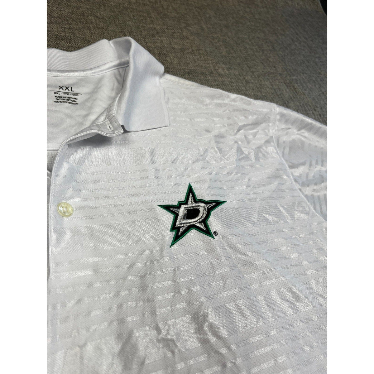 Second Half Supply Co, LLC white Antigua Dallas Stars polo shirt with tonal geometric pattern and embroidered logo