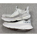 Second Half Supply Co, LLC pre-owned white HOKA Clifton 9 women's running shoes with visible wear and discoloration.