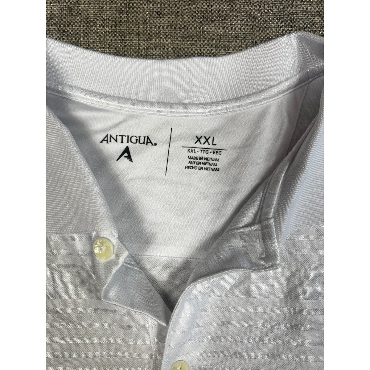 Second Half Supply Co, LLC Antigua white polo shirt with tonal geometric pattern and XXL size tag detail