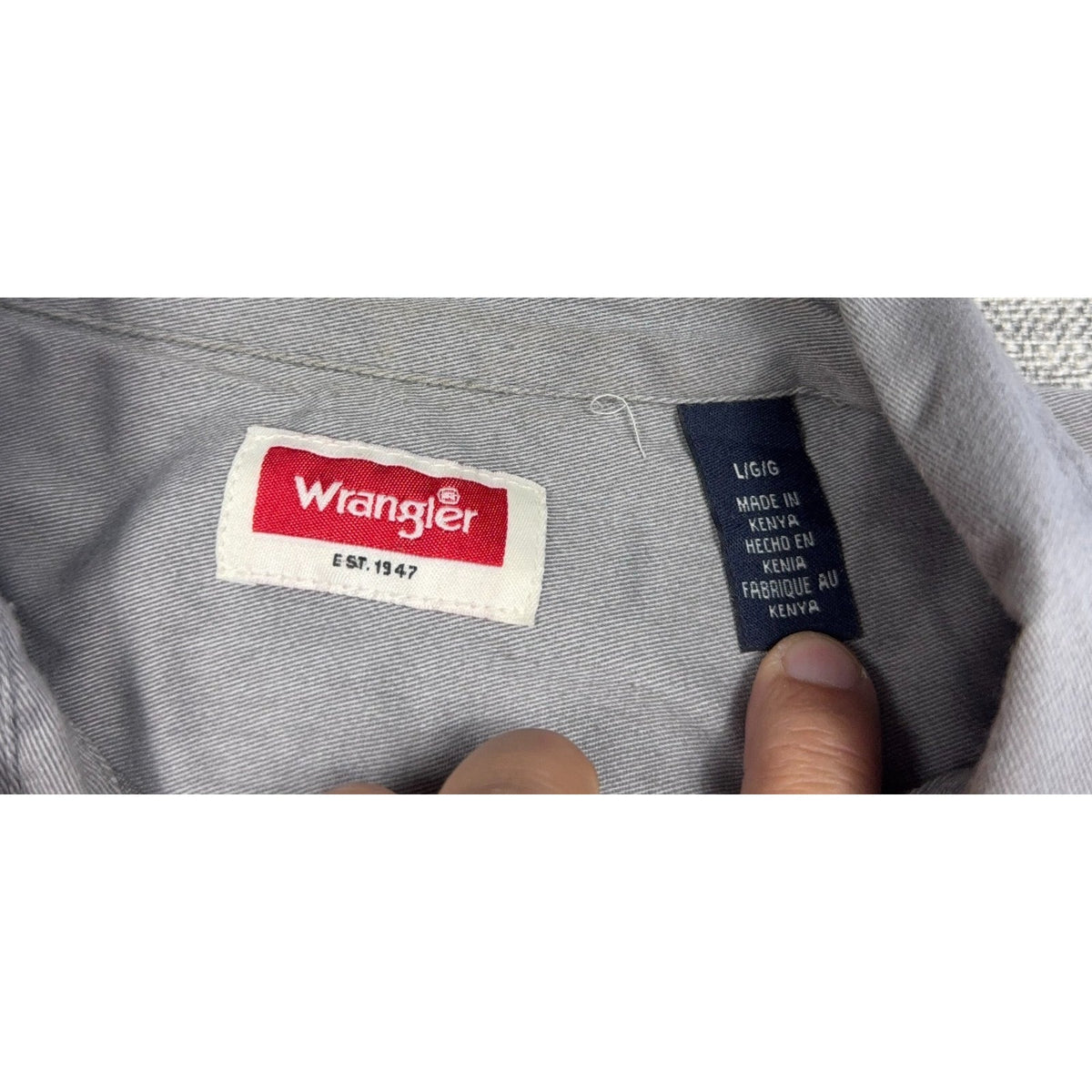 Second Half Supply Co, LLC Wrangler gray shirt interior brand and size label showing size Large and made in Kenya