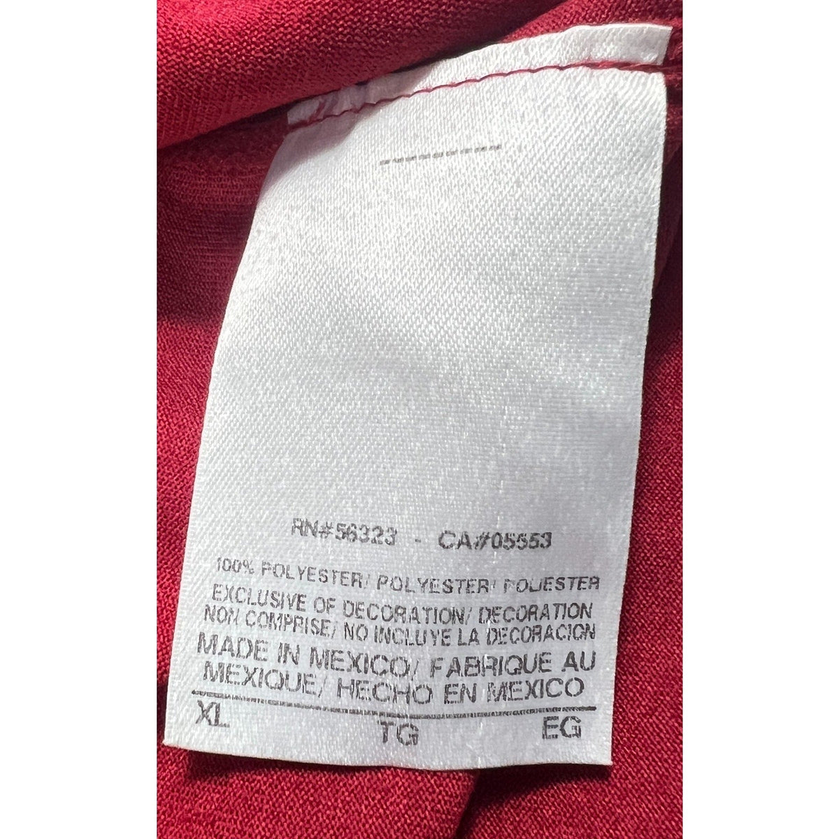 Second Half Supply Co, LLC Nike shirt care label showing 100% polyester material and XL size made in Mexico